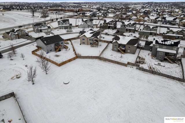 snowy aerial view featuring a residential view