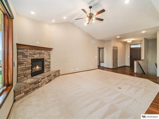 unfurnished living room with visible vents, baseboards, ceiling fan, a fireplace, and beam ceiling