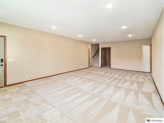 empty room with baseboards, stairway, light carpet, and recessed lighting