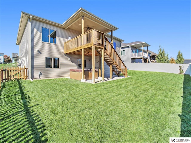 rear view of house with a yard, stairway, a fenced backyard, and a wooden deck