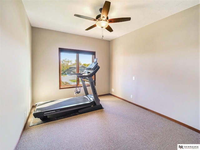 exercise room featuring carpet floors, a ceiling fan, and baseboards