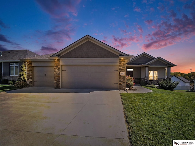 view of front of property with a garage, stone siding, a lawn, and concrete driveway