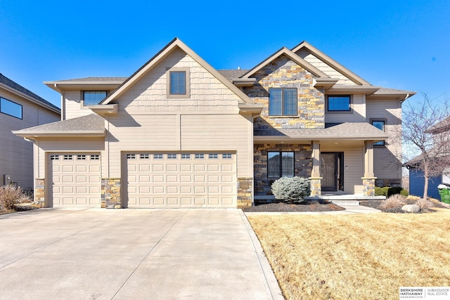 craftsman-style house with a garage, stone siding, a shingled roof, and concrete driveway