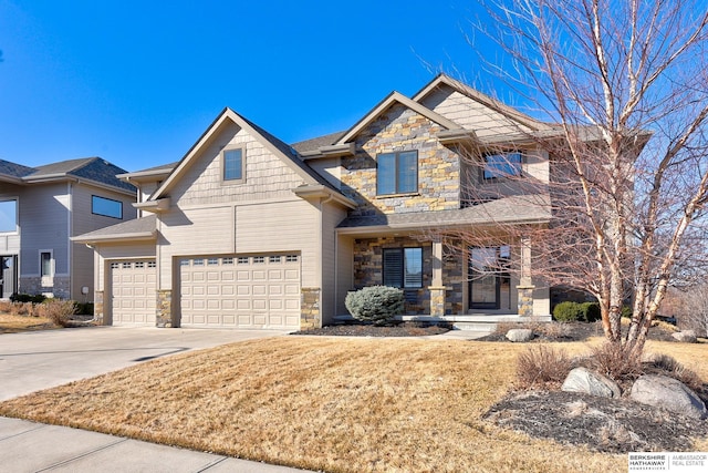 craftsman house with an attached garage, stone siding, concrete driveway, and a front yard