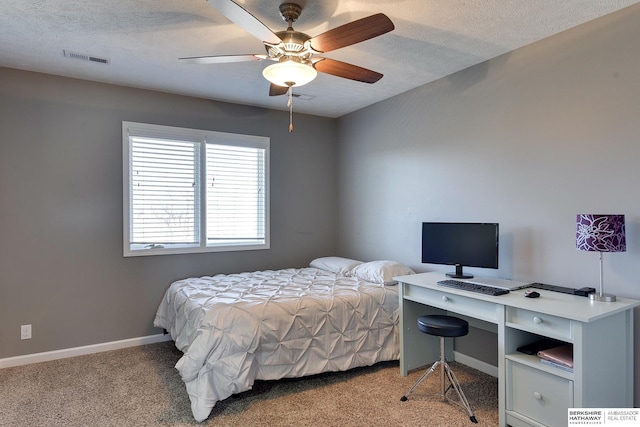 bedroom featuring baseboards, a textured ceiling, visible vents, and light colored carpet