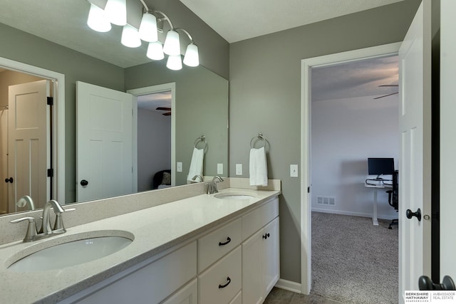 bathroom featuring double vanity, baseboards, visible vents, and a sink