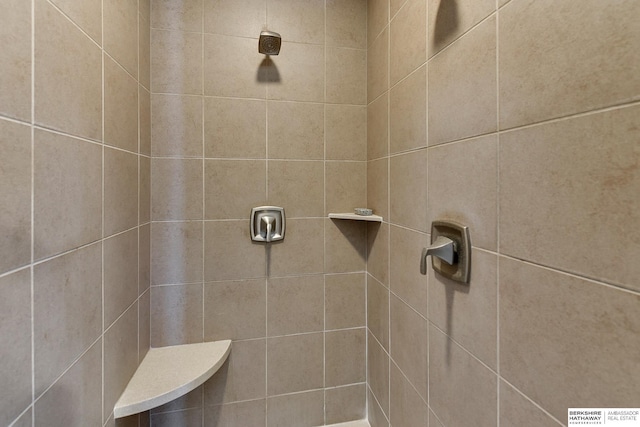 bathroom with a tile shower