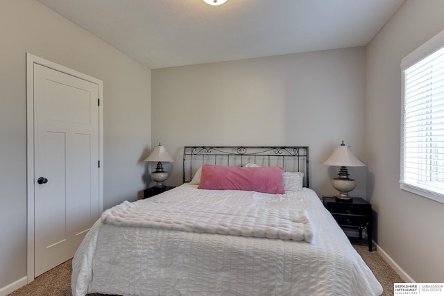 bedroom with carpet floors and baseboards