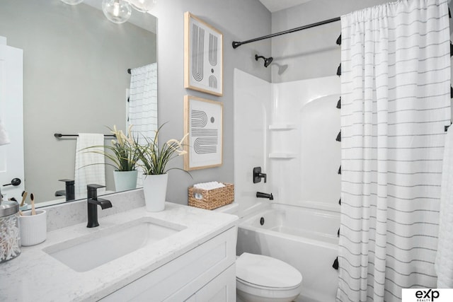 bathroom featuring shower / bath combo, vanity, and toilet