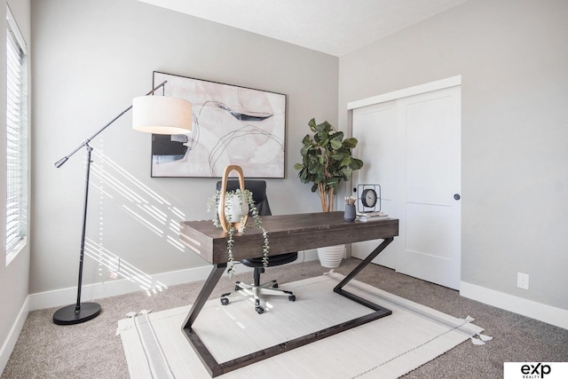 home office with carpet floors, plenty of natural light, and baseboards