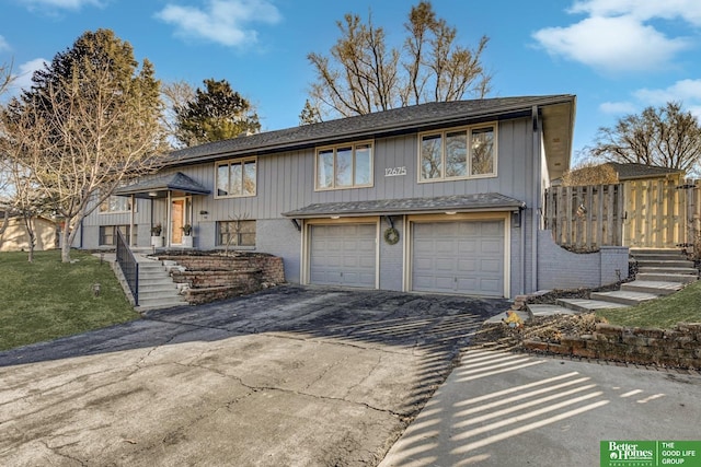 view of front facade featuring a garage, driveway, brick siding, and a front lawn