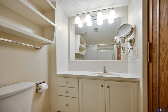 full bathroom with decorative backsplash, toilet, a shower with shower door, a textured ceiling, and vanity