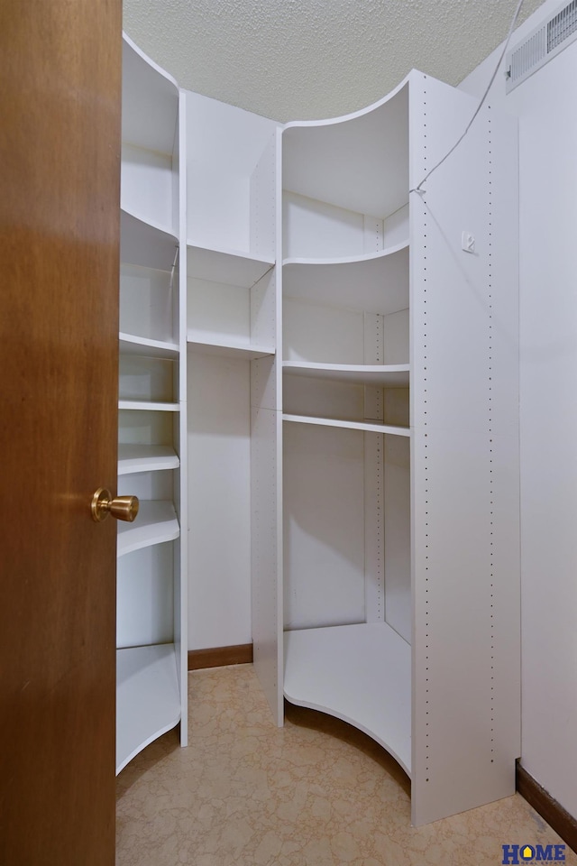 spacious closet featuring visible vents