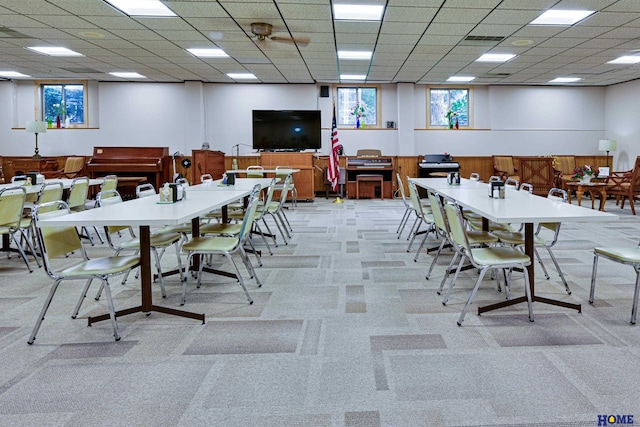 dining space featuring a paneled ceiling, light carpet, and visible vents