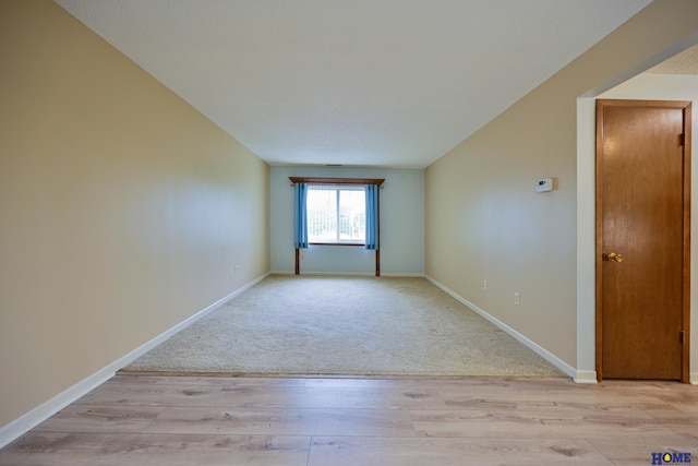 unfurnished room featuring light wood-type flooring and baseboards