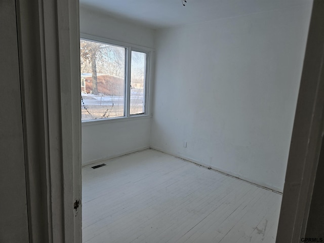 empty room featuring light wood-style flooring and visible vents