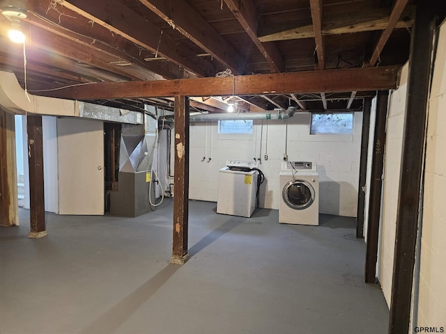 basement with washing machine and dryer and heating unit