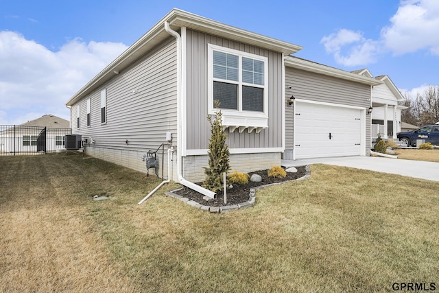 view of front of property featuring a garage, central AC unit, concrete driveway, fence, and a front yard