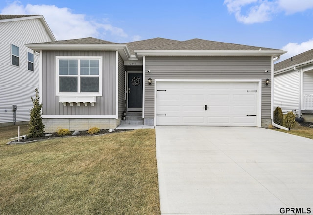 view of front of home with board and batten siding, an attached garage, driveway, and a front lawn