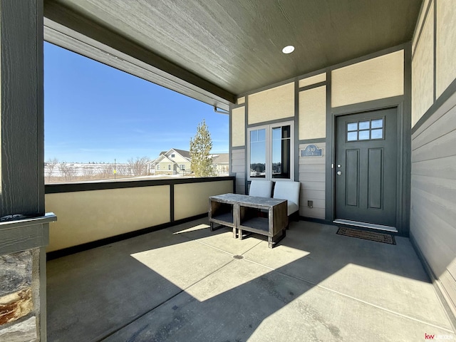 view of exterior entry with a balcony