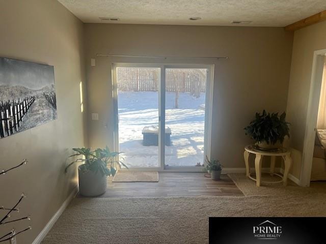 entryway with a textured ceiling and baseboards