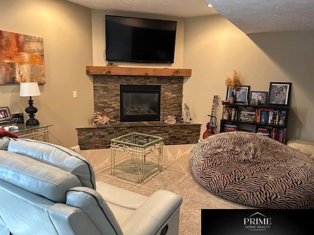 living area featuring a stone fireplace