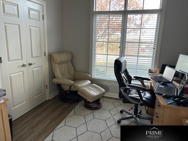 office space with baseboards and wood finished floors