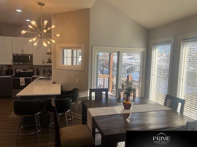 dining room featuring baseboards, dark wood-style flooring, an inviting chandelier, and a healthy amount of sunlight