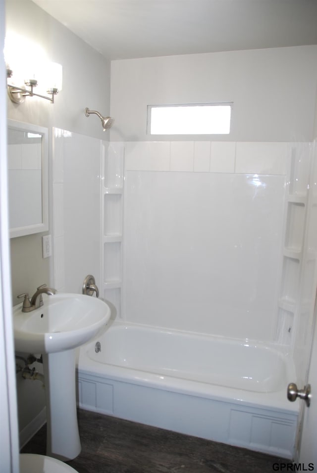 full bathroom with shower / washtub combination and wood finished floors