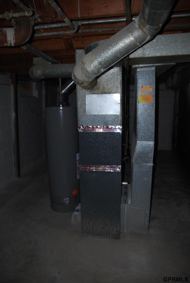 utility room with heating unit and gas water heater