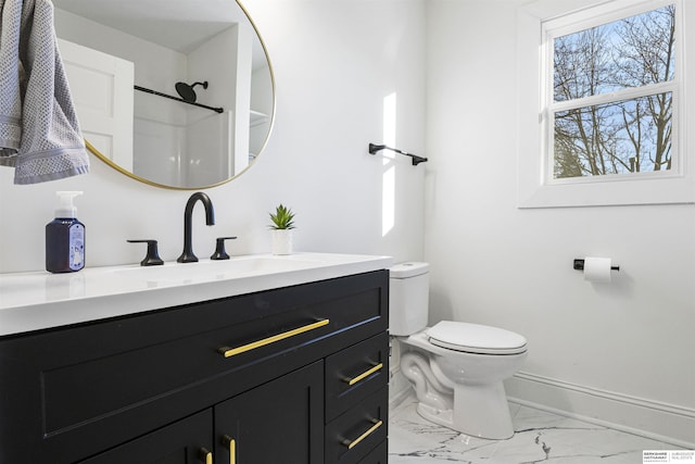 bathroom with baseboards, a shower, toilet, marble finish floor, and vanity