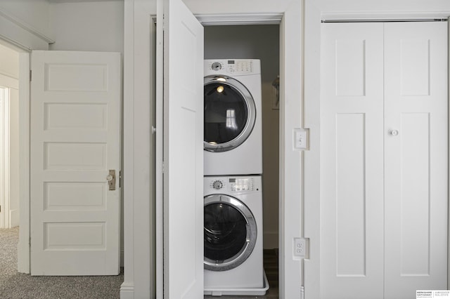 washroom with stacked washer and dryer and laundry area