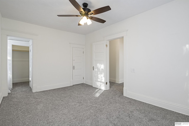 unfurnished bedroom featuring carpet floors, baseboards, and a ceiling fan