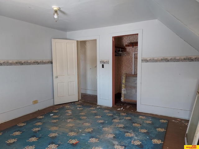 unfurnished bedroom with lofted ceiling