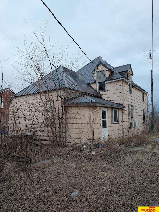 back of house featuring cooling unit