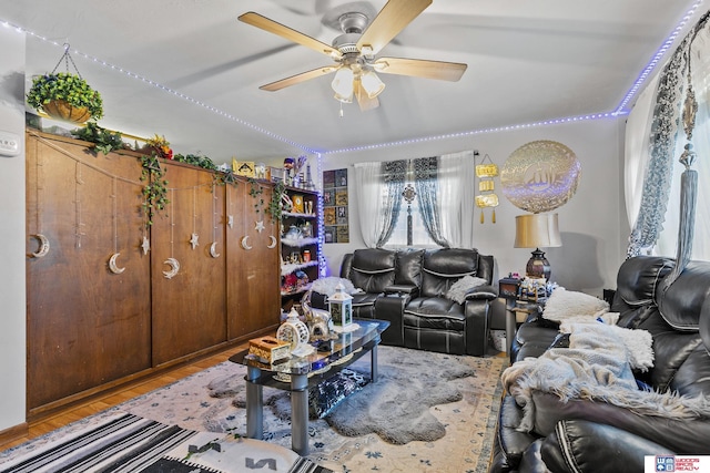 living room with ceiling fan and wood finished floors