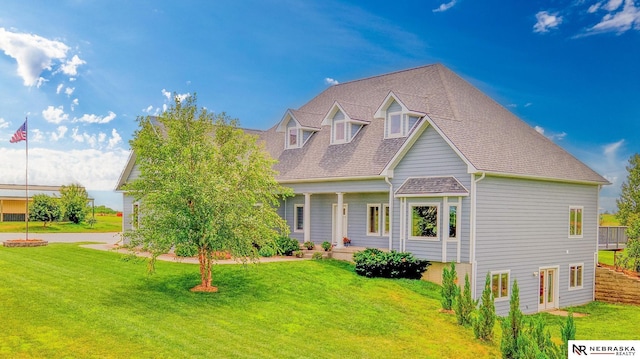 cape cod-style house with a front lawn and a shingled roof