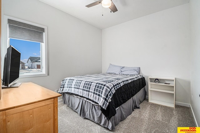 bedroom with dark carpet, a ceiling fan, and baseboards