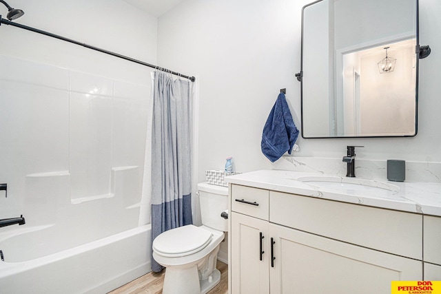 bathroom featuring toilet, vanity, wood finished floors, and shower / bath combo with shower curtain