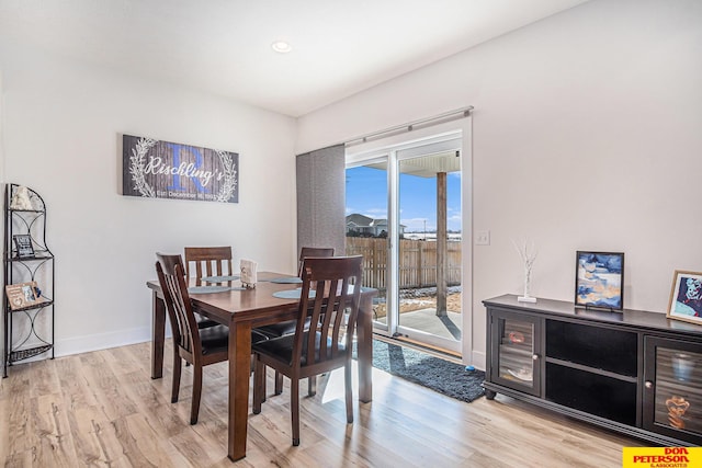 dining area with light wood-type flooring, baseboards, and recessed lighting