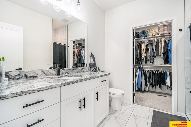 full bathroom featuring toilet, marble finish floor, a shower with curtain, and vanity