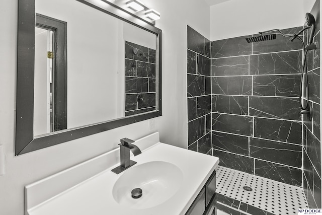 bathroom featuring a shower stall and vanity