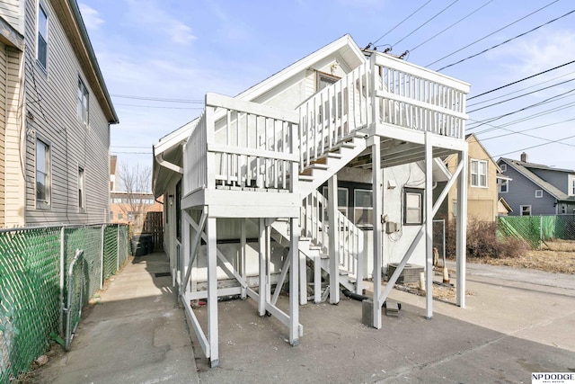 view of front of property featuring stairs and fence