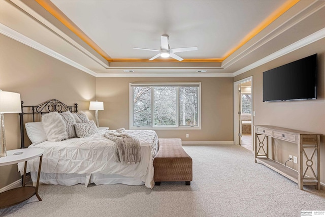 bedroom with crown molding, a tray ceiling, and carpet flooring