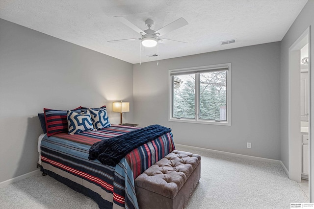 carpeted bedroom with a ceiling fan, baseboards, visible vents, and a textured ceiling