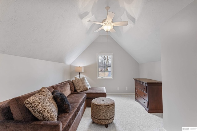 living area with lofted ceiling, light colored carpet, a ceiling fan, a textured ceiling, and baseboards