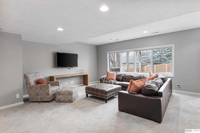 carpeted living area featuring recessed lighting, visible vents, a textured ceiling, and baseboards