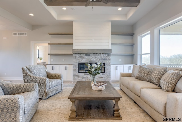 living area featuring ceiling fan, recessed lighting, a fireplace, visible vents, and beam ceiling