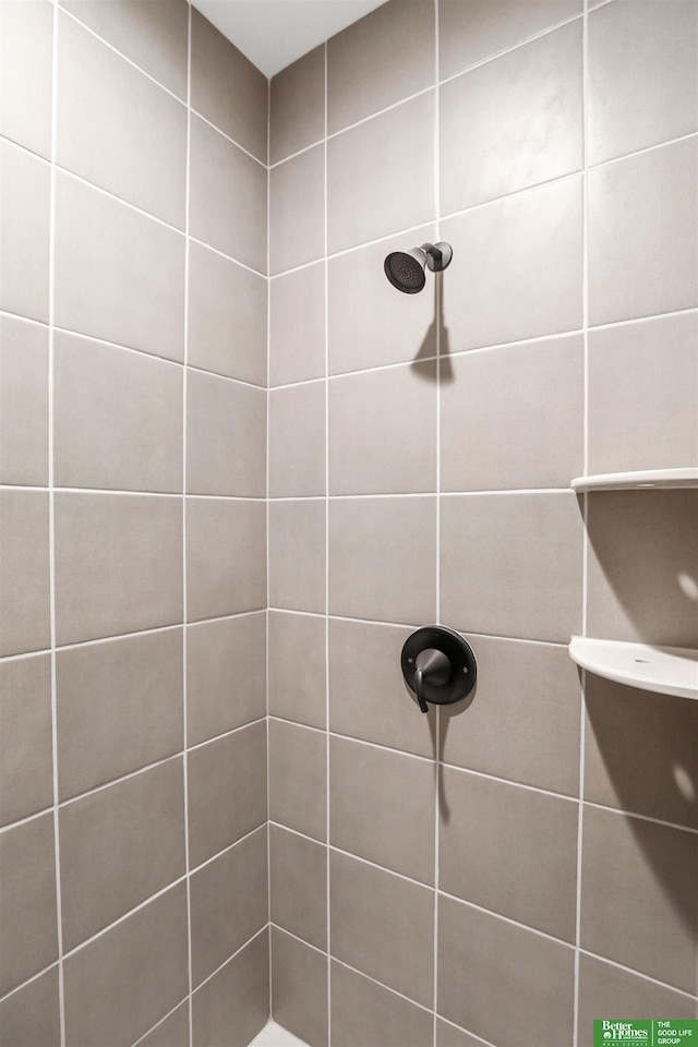 bathroom with tiled shower