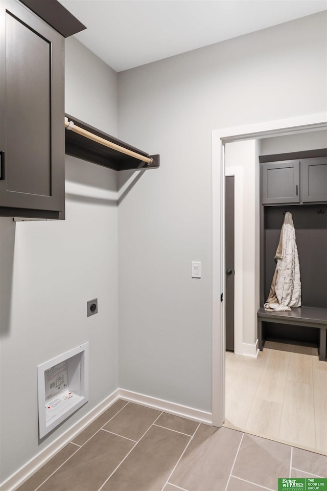 washroom featuring laundry area, baseboards, and hookup for an electric dryer